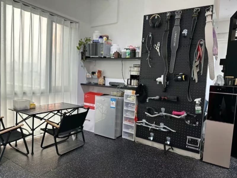 A DIY installation showing a rubber mallet tapping an interlocking gym ramp into place.